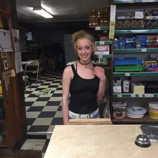a woman standing behind a counter