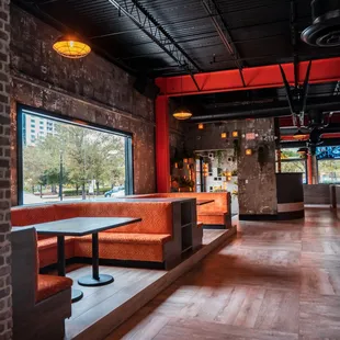 a restaurant with brick walls and booths