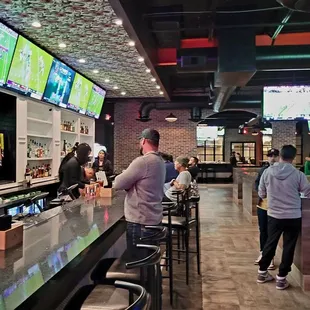 people watching a football game on tvs