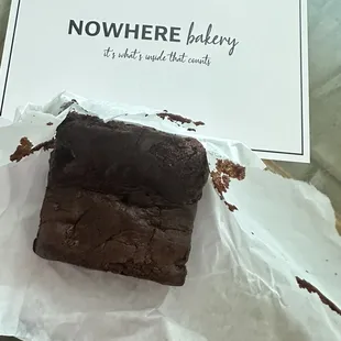 a chocolate brownie on a piece of paper