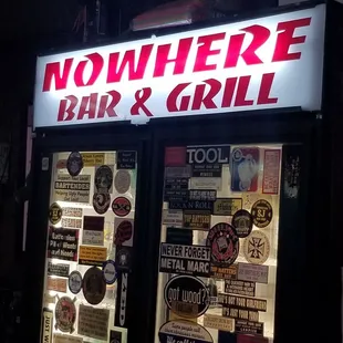 a neon sign for nowhere bar and grill