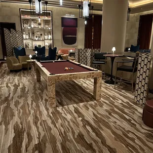 a pool table in a hotel lobby