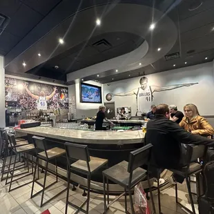 a group of people sitting at a bar
