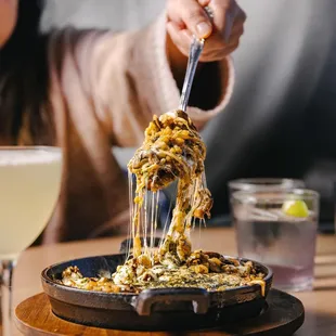 a woman eating spaghetti with a fork