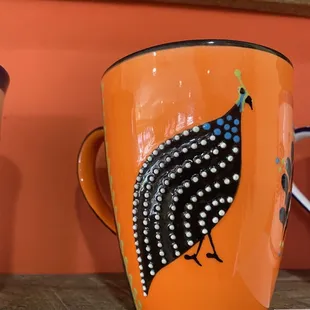 a bird painted on a cup