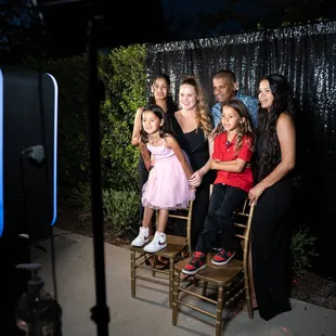 Family taking pictures on our photo booth!