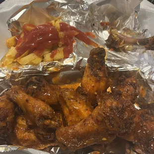 Hot lemon pepper wings and fries.