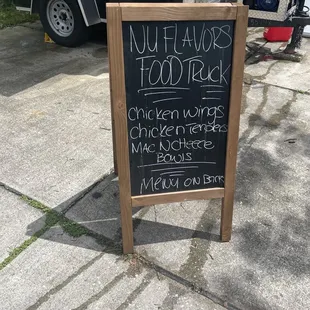 a chalkboard sign on a sidewalk
