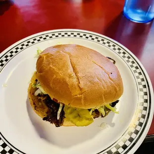 a hamburger on a plate on a table