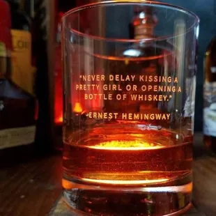 a glass of whiskey on a table