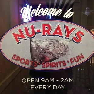 a neon sign in the window of a restaurant