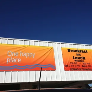 a one happy place banner on a building