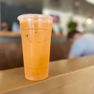 a plastic cup of orange juice