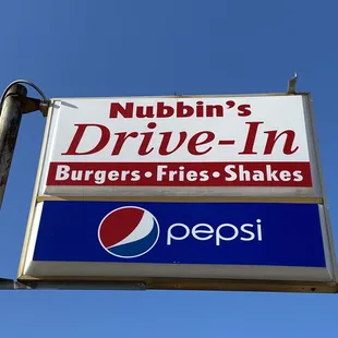 a sign for nubbin&apos;s drive - in burgers and fries shakes