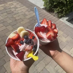 two bowls of fruit and yogurt