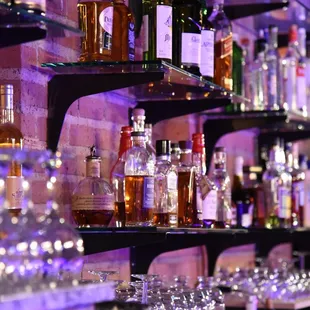 a shelf of liquor bottles