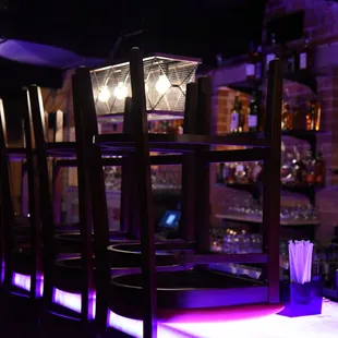 a bar with purple lighting