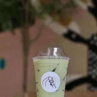 a green drink in a plastic cup