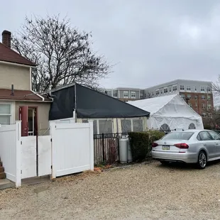 a car parked in front of a tent