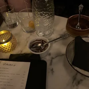 a table with a menu and glasses