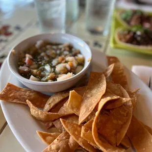 a plate of chips and a bowl of salsa