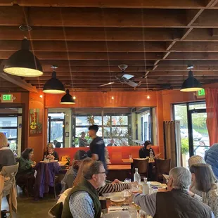 a large group of people eating in a restaurant