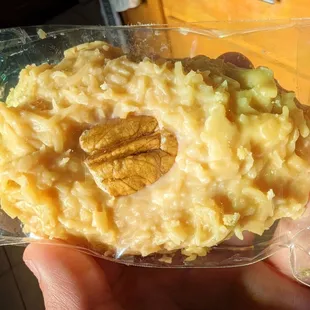 a hand holding a bag of rice pudding