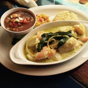 Mariscos Poblanos is a mix of shrimp scallops fish with a white creamy sauce pot beans and with rice.