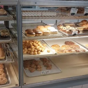a variety of donuts in a display case