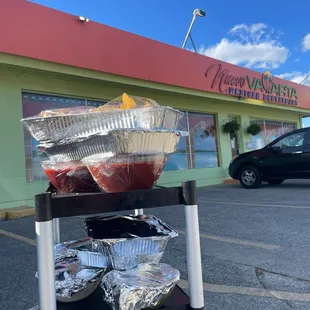 a cart of food in front of a restaurant