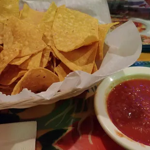 a bowl of chips and a bowl of salsa