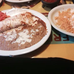 Ground beef burrito fiesta with rice on the side