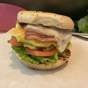 Bagel egg turkey ham and cheese with avocado and veggies