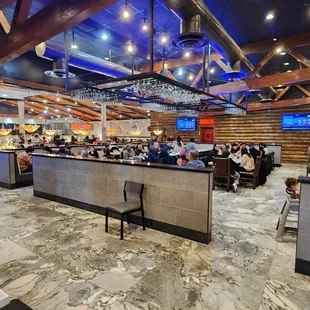 people sitting at tables in a restaurant