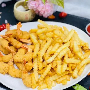 a plate of fried shrimp and fries
