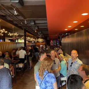 a large group of people sitting at tables in a restaurant