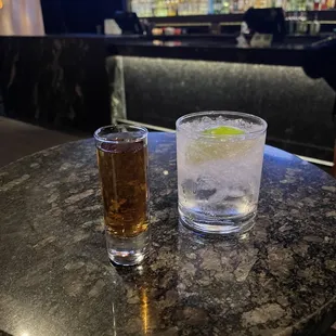 two glasses of alcohol on a table