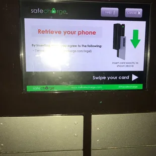a safe charge sign on a public phone