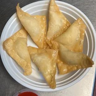a plate of wontons on a table