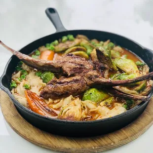 Lamb chops over noodles with clams, peas and Brussels, yummy!