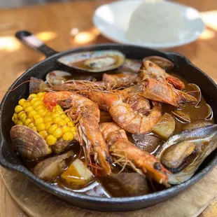 Seafood special - Seared salmon, fingerling potatoes, boiled shrimps, new zealand mussels, clams, and fresh corn with rice.