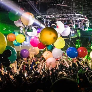 a crowd of people with balloons