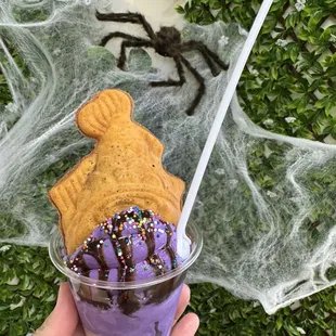 Soft serve cone in a cup ube with Nutella filling. Topping: sprinkle and chocolate drizzle