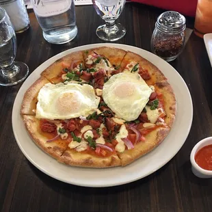 Life is better with an egg on top!!! Breakfast pizza was delicious, added some homemade piri piri on top.