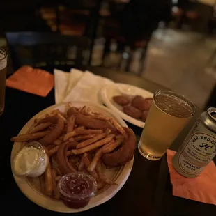 a plate of fries and a can of beer