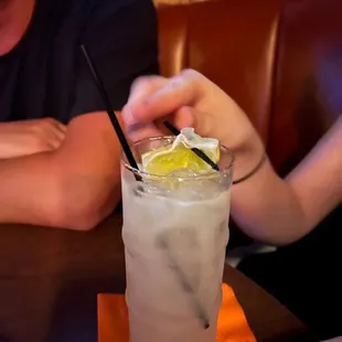 a woman holding a glass of lemonade