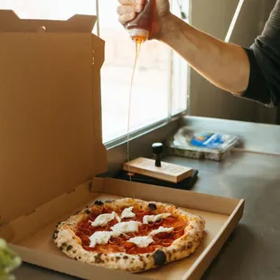 a person holding a slice of pizza
