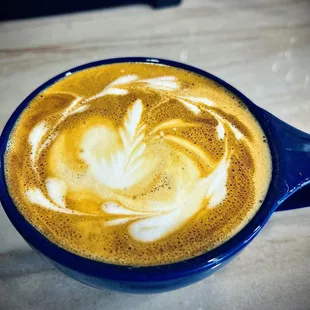 a latte in a blue cup