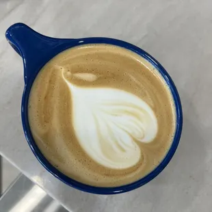 a latte in a blue bowl