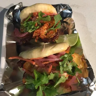 two sandwiches on tin foil